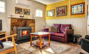 a living room with a couch and a fireplace at Bonnie Brae Cottage in Hepburn Springs