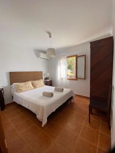 a bedroom with a bed with two pillows on it at Ca na Brila in Campos