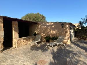 a group of chairs sitting on a patio at Ca na Brila in Campos