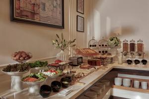 a buffet with bowls of food on a counter at NIA Hotel in Da Lat