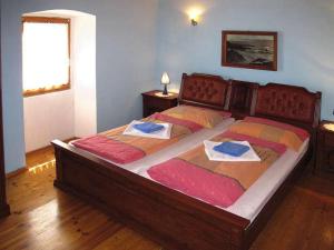 a bedroom with a large bed with two towels on it at Holiday Home Kastel in Kaštel