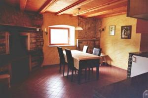 a dining room with a wooden table and chairs at Holiday Home Kastel in Kaštel