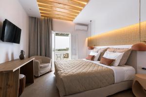 a hotel room with a large bed and a television at Pnoi Hotel in Logaras +90 photos