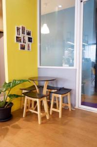 a table and two chairs in a room with a window at Sleep cafe @ Hidee in Bangkok