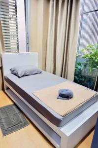 a bed with two pillows on top of it at Sleep cafe @ Hidee in Bangkok