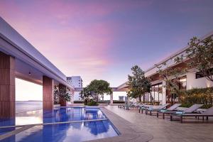 a swimming pool in the middle of a building at RIVA Hotel SHV in Sihanoukville