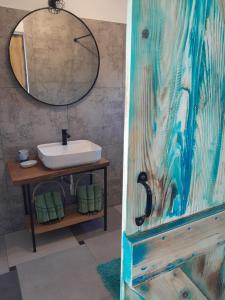 a bathroom with a sink and a mirror at MARANGUN Drage apartman in Drage +38 photos