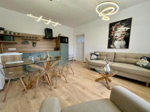 a living room with a glass table and a couch at MILLAR's in Sovata