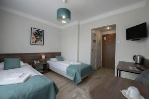 Posteľ alebo postele v izbe v ubytovaní Hotel Polonia