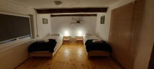 a room with two beds and a flat screen tv at Przystań Osiek in Osiek