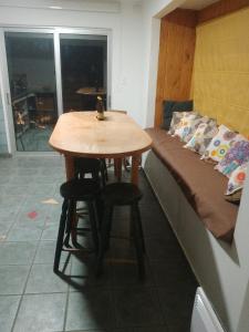 a table and stools in a room with a bed at casa Wamani in Santiago +20 photos