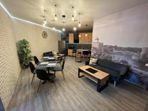 a living room with a couch and a table and chairs at Santel Apart Hostel in Narva
