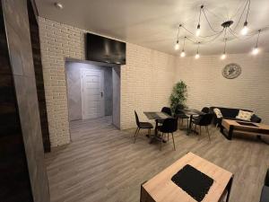 a dining room with tables and chairs and a brick wall at Santel Apart Hostel in Narva