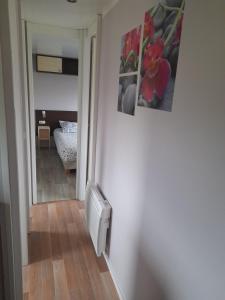a hallway with a mirror and a room with a bed at Mobil home au plein cœur de la nature in Bardenac