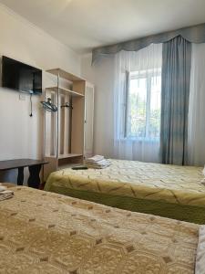 Postel nebo postele na pokoji v ubytování Guest House Arbat