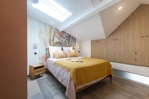 a bedroom with a large bed with a skylight at Villa fleurie in Cagnes-sur-Mer
