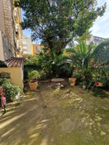 a park with a bench and a tree in a yard at Family Room in Nice