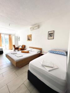 Postel nebo postele na pokoji v ubytování Apartments Mango + 37 fotografií