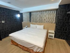 Postel nebo postele na pokoji v ubytování 瑾旅南西館 Gininn NanXi