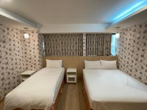 Postel nebo postele na pokoji v ubytování 瑾旅南西館 Gininn NanXi