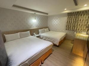Postel nebo postele na pokoji v ubytování 瑾旅南西館 Gininn NanXi