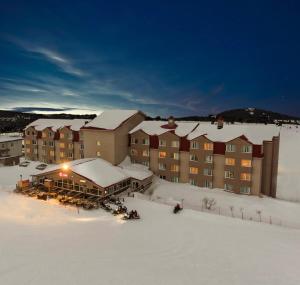 a resort in the snow with snow covered buildings at Kaya Uludag in Uludag