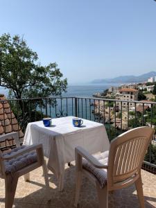 a table and chairs on a balcony with the ocean at Villa Lila in Utjeha