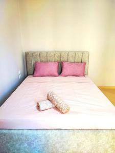 a large bed with two pillows on top of it at Dahlila's Home in Pogradec
