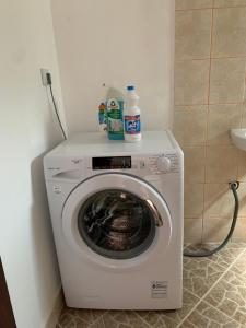 a washing machine with bottles on top of it at Villa Lila in Utjeha
