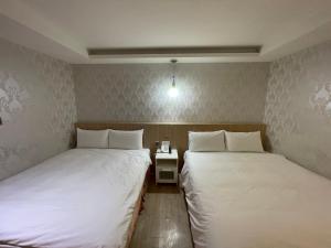 Postel nebo postele na pokoji v ubytování 瑾旅南西館 Gininn NanXi