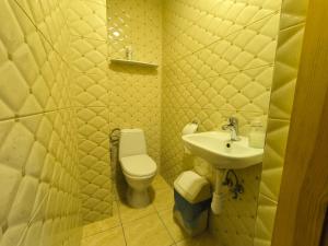 a bathroom with a toilet and a sink at Poilsis Palangoje pas Daivą in Palanga