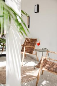 a chair and a table with a glass of wine at Akti Hotel Kavala in Paleo Tsifliki