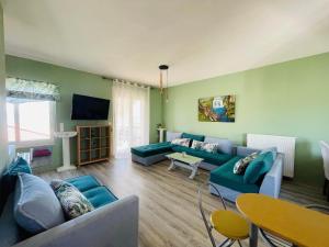 a living room with blue couches and a television at Selini Seaview Villa in Kissamos