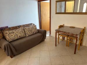 a living room with a couch and a table at Apartment 2 (+1) in Ljubač +6 photos