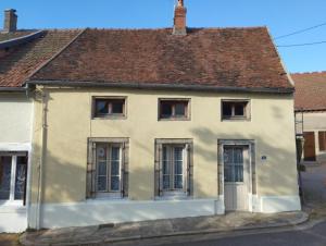 a white house with windows and a brown roof at Gîte de la danse in La Roche-en-Brenil