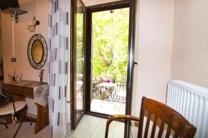 a room with a door to a patio with a table at Naftilos Guest House in Kala Nera +45 photos