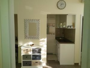 a kitchen with a sink and a clock on the wall at Apartment Katarina in Banja Koviljača