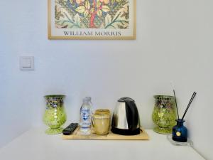 a shelf with vases and a coffee maker on it at Fedora Otel Alaçatı in Alaçatı