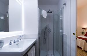 a bathroom with a sink and a shower at Amalfi Luxury House in Amalfi