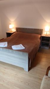 a bedroom with a bed with two lamps on two tables at Guesthouse Mabu - 4 Newly Built Rooms in the Heart of Mestia in Mestia