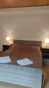 a bed with two white towels on top of it at Guesthouse Mabu - 4 Newly Built Rooms in the Heart of Mestia in Mestia