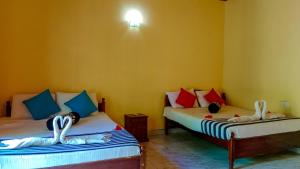Letto o letti in una camera di Sigiri Thilanka Rest Sigiriya