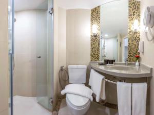 a bathroom with a toilet and a sink and a shower at Ibis Phuket Patong in Patong Beach +31 photos