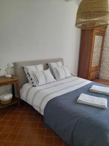 a bedroom with a large bed with towels on it at Vacation Rental in Ambleville