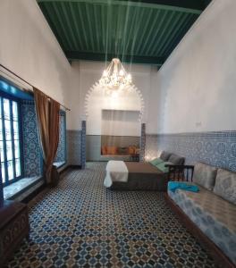 a large room with a bed and a chandelier at Maison De La Lune in Tétouan