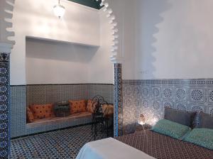 a bedroom with a bed and a fireplace at Maison De La Lune in Tétouan