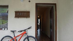 a bike parked next to a wall with a rite sign at Arte in Kazbegi in Kazbegi