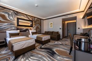 Postel nebo postele na pokoji v ubytování Hotel Debrecen