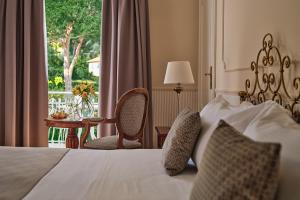 a hotel room with a bed and a window at Grand Hotel Miramare in Santa Margherita Ligure
