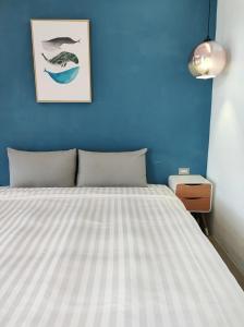 Łóżko lub łóżka w pokoju w obiekcie Kenting Cozy B&B